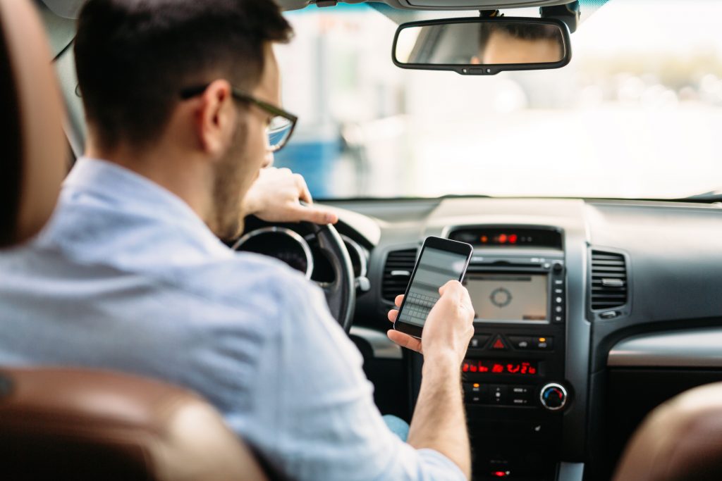 Man texting while driving