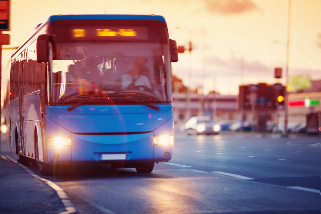 Bus pulling up to a bus stop