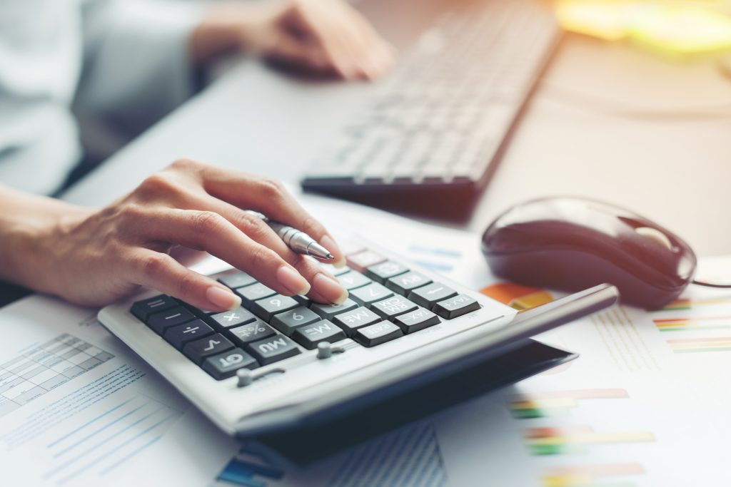 Person using a calculator at the computer