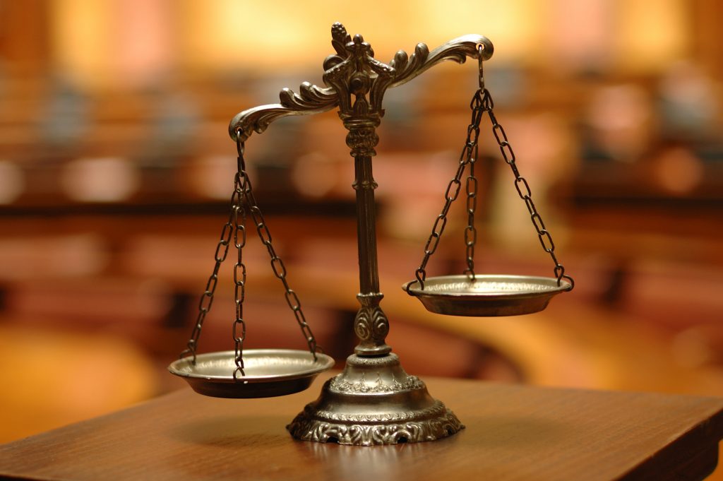 Scales of justice on a wooden table