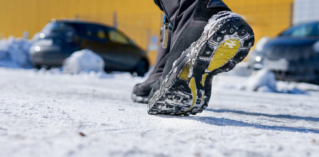 winter boots walking on an icy sidewalk