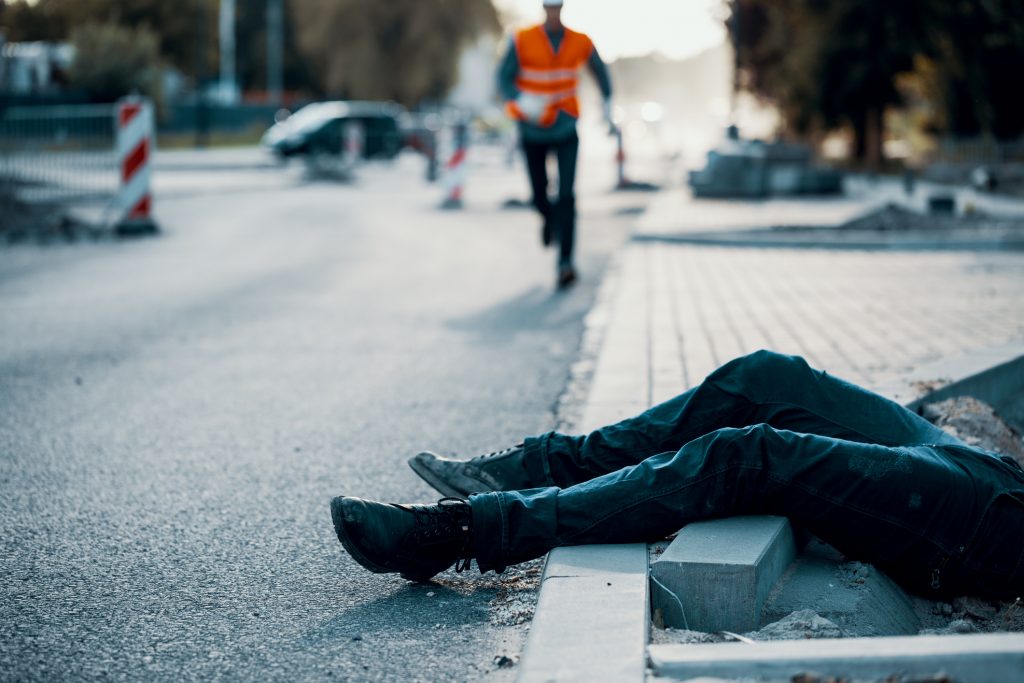 Woman laying on sidewalk after a fall