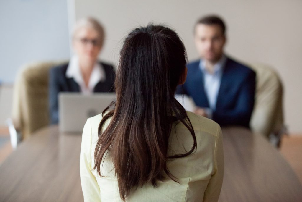 Woman being interviewed by two people