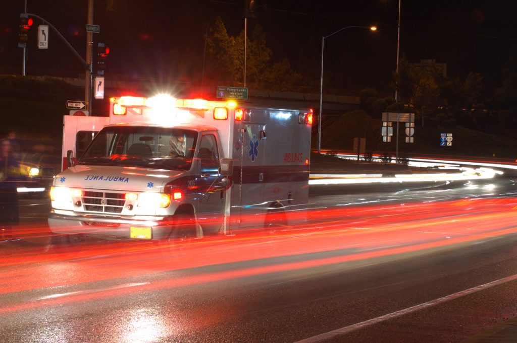 Ambulance with lights on in traffic