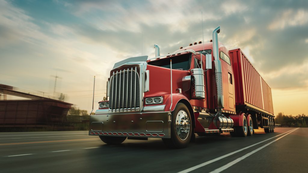 A red semi truck on the highway