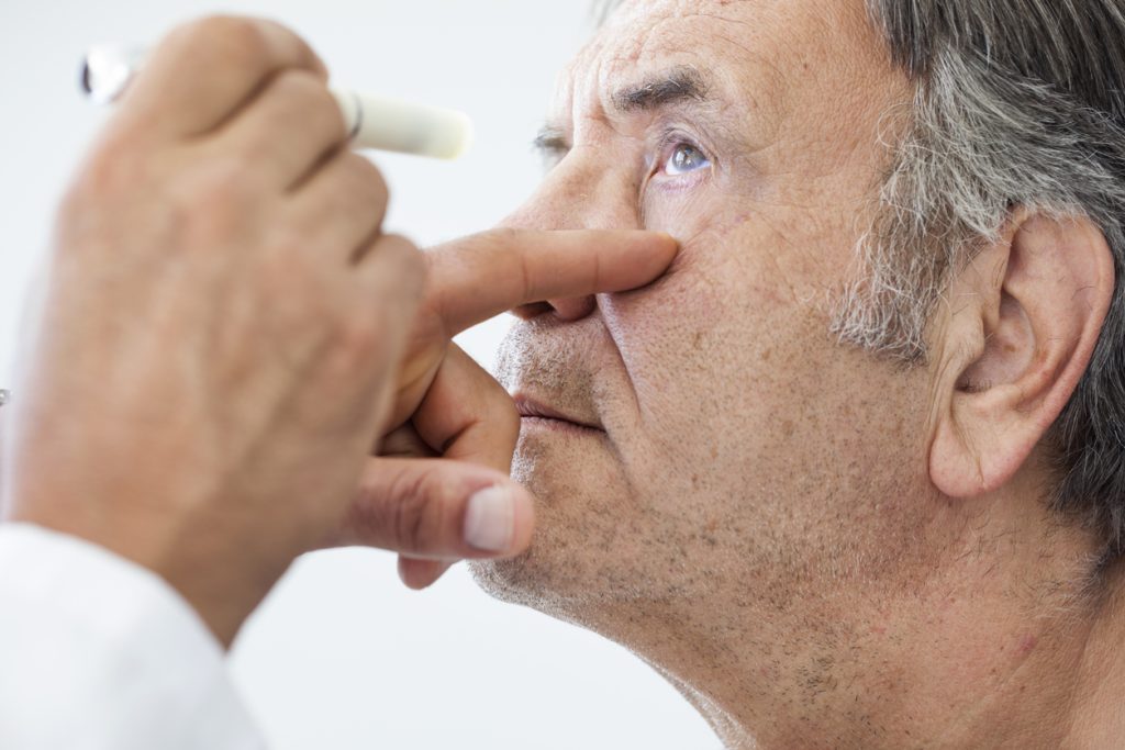 Elderly man receiving an eye examination