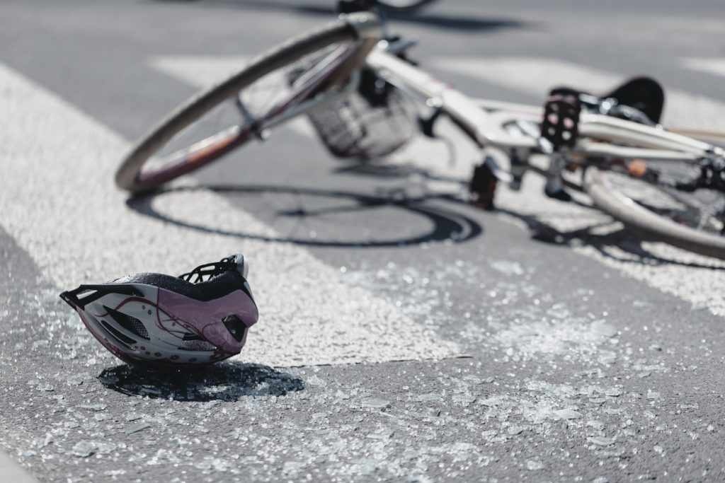 A bike and helmet in the street after an accident