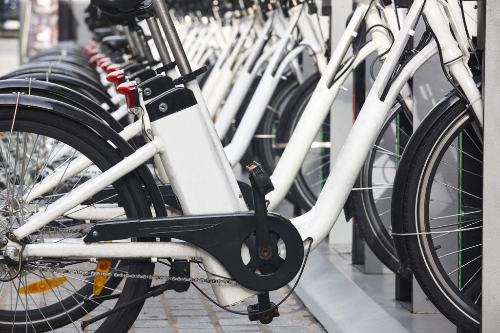 A rack of electric bikes for rent in the city