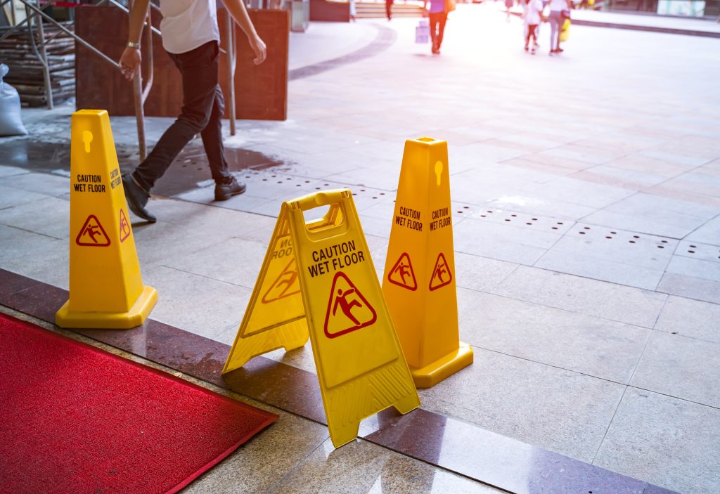 Wet floor signs in the entrance to a building