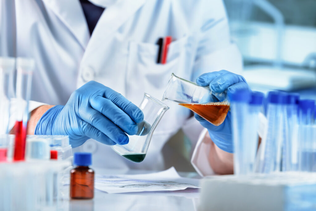 A scientist mixing chemicals in a beaker